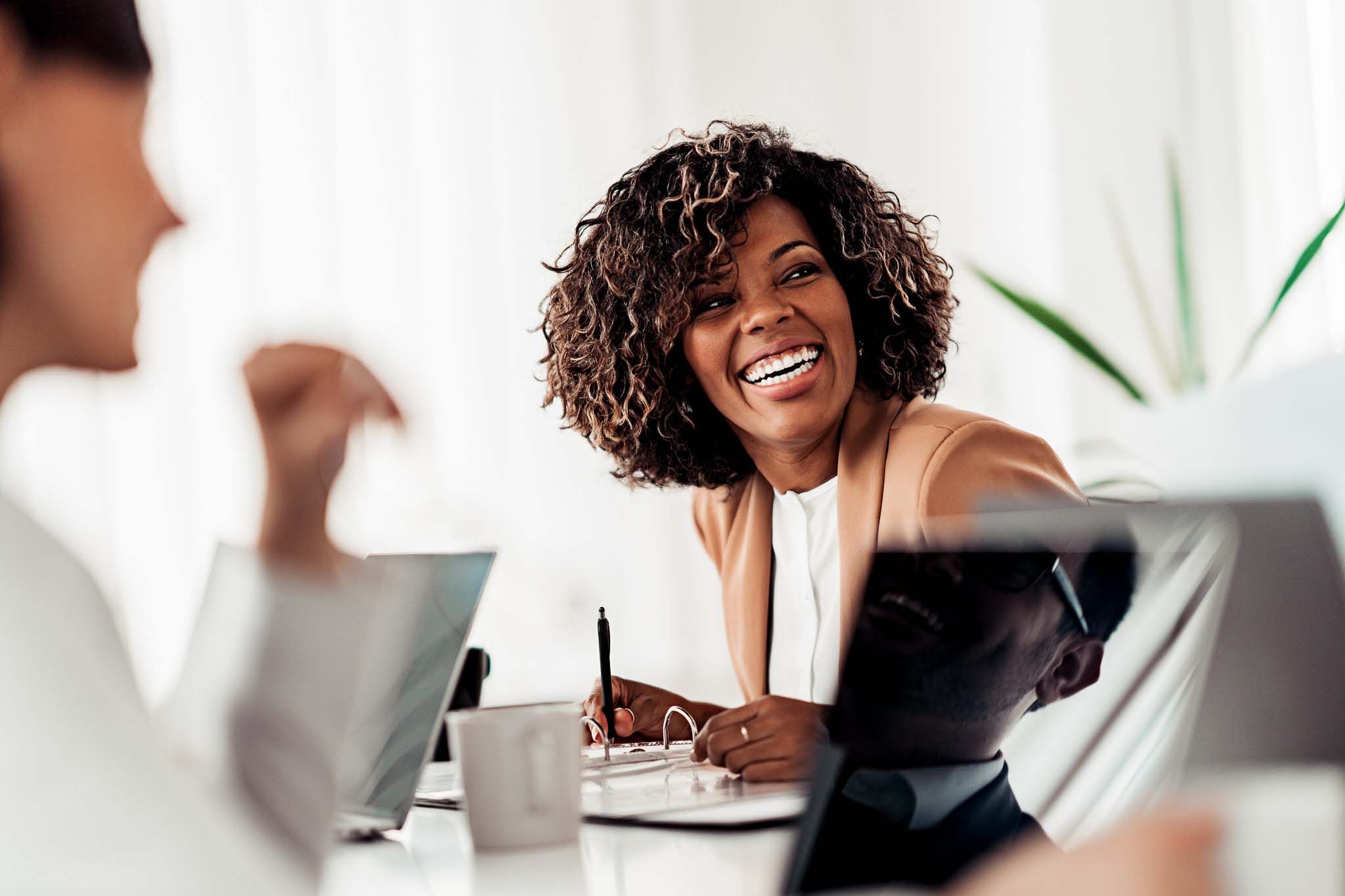 Portrait of cheerful businesswoman smiling at the meeting