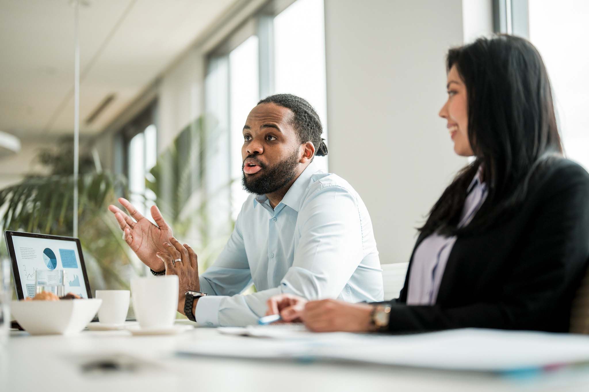 Multiracial Female and Male Business Partners in Meeting