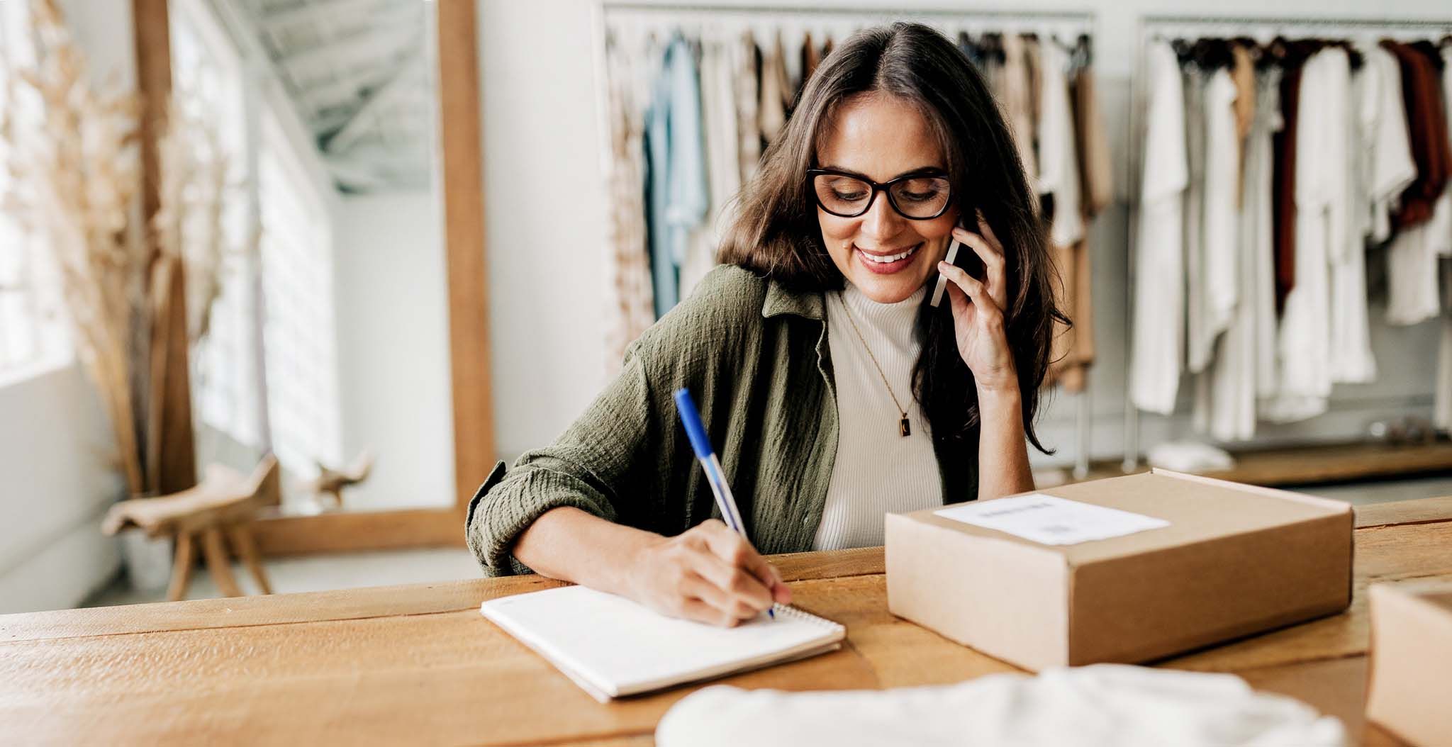 Running an online store: Ecommerce entrepreneur confirms a shipping on the phone