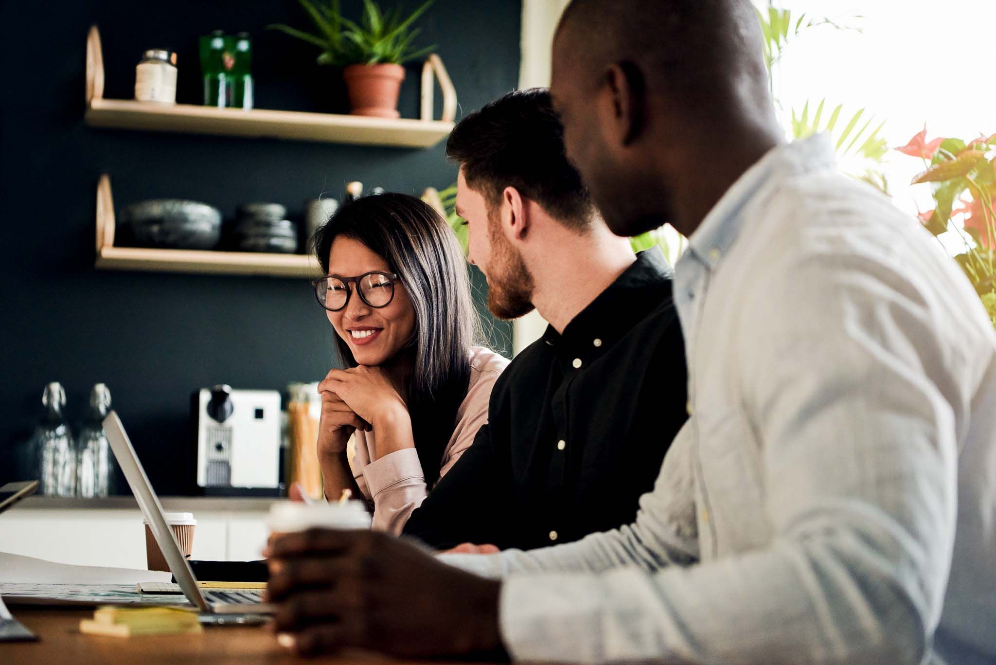 Diverse group of smiling colleagues working together in an office